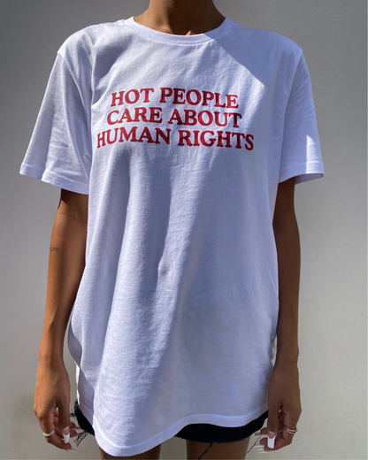 White t-shirt with red text 'HOT PEOPLE CARE ABOUT HUMAN RIGHTS' worn by a person on a plain background